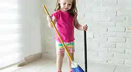 young child sweeping